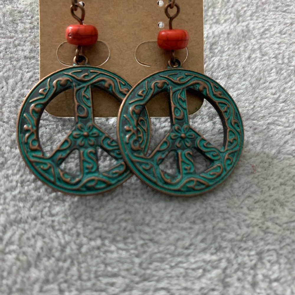 Cute PEACE earrings. New without tags. Green and copper.